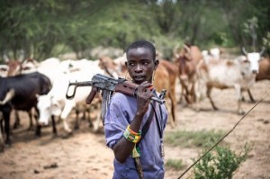 Herdsman (cattle rearer) carrying an automatic weapon