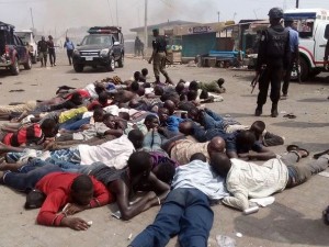 People being held by the Nigerian Police during a deadly fight between the Yoruba and Hausa people in Agiliti, Mile 12, Lagos state on 3 March 2016