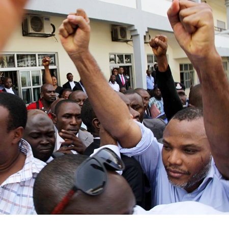 Nnamdi Kanu acknowledges cheers from his numerous supporters by raising his clenched fists