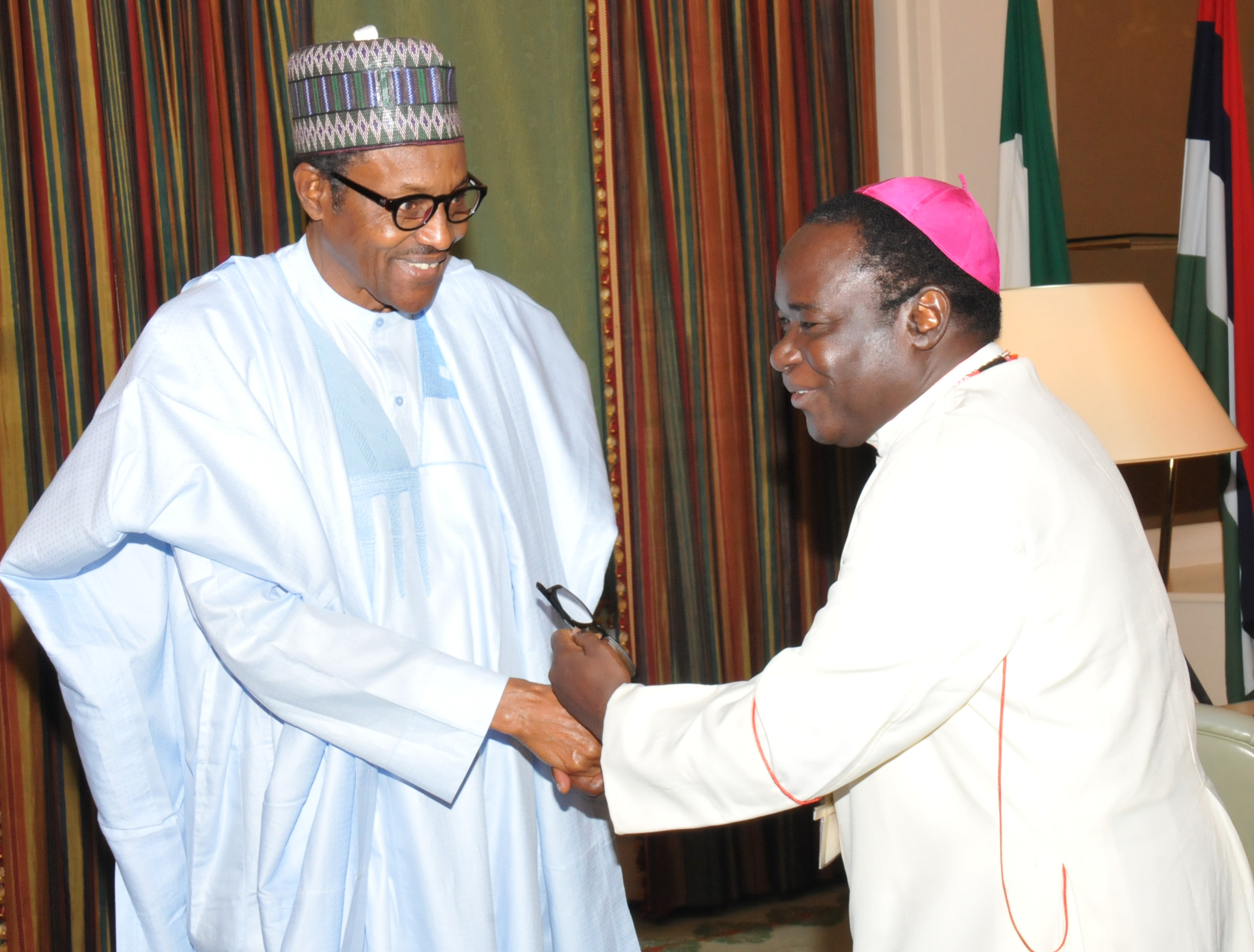 President Muhammadu Buhari (L) and Bishop Matthew Hassan Kukah of the Catholic Diocese of Sokoto