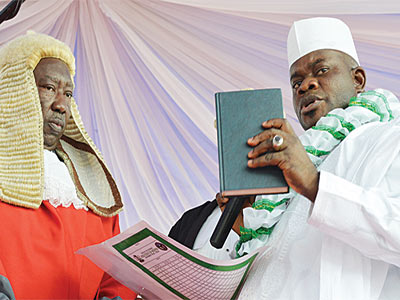 Yahaya Bello (right), taking oath of office as Governor of Kogi State at his inauguration before the Chief Judge of the state, Justice Nasiru Ajana, in Lokoja, 27 January 2016. (Image credit: NAN)