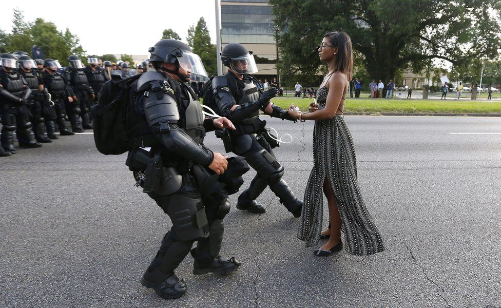 Riot police squad seizes a protester, Ieshia Evans, in Baton Rouge; this iconic photo shot by Jonathan Bachman has gone viral. (Photo credit: Jonathan Bachman / Reuters)