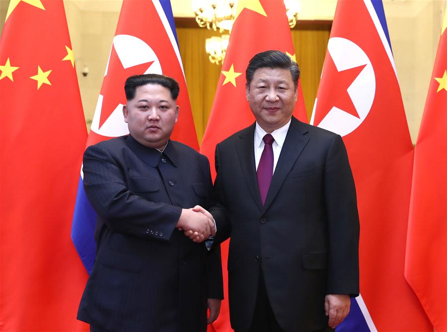Kim Jong Un (L) and Xi Jinping. (Image credit Xinhua/Ju Peng)