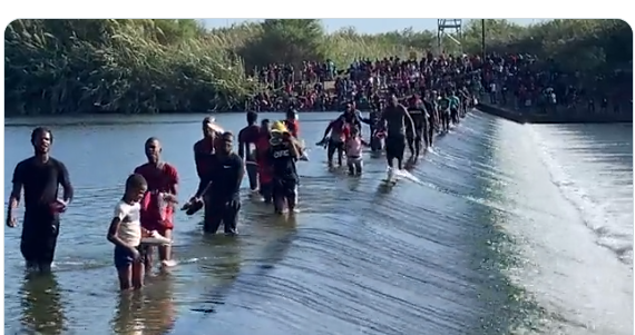 Thousands of migrants walking across a dam in the Rio Grande, heading to Del Rio International Bridge in South Texas (Foxnews/@BillFOXLA)